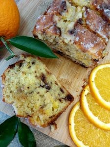 Sliced Orange Chocolate Loaf Cake on a wooden board