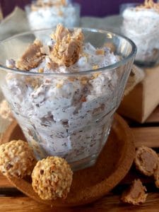 Giotto Cream Dessert in a glass with scattered Giottos on a wooden table.