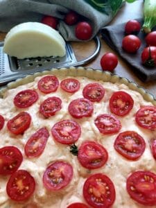 Close up of prepared tomato Zucchini Quiche ready for the oven.