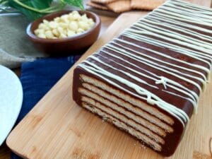 Close-up of a no-bake chocolate cake on a wooden board.