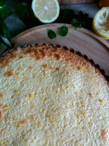 Baked lemon tart on a wooden platter