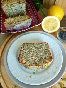 Slice of a Lemon Poppy Seed Loaf on a white plate.