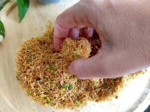 Cheesecake Bites being coated with crisp kataifi.