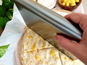 Cutting the dough into 8 wedges using a bench scraper