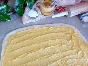 Evenly distributed Mango Curd on a rolled out dough.