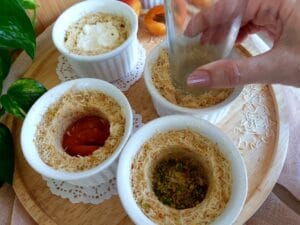 Soufflé tins filled with kataifi, pistachios, and cheese.