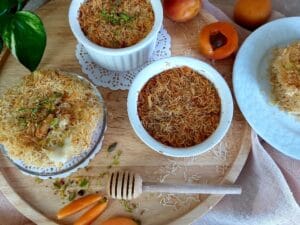 Apricot Pistachio Kataifi Tartlets on a wooden board.