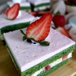 Sliced Strawberry Spinach Cake in a wooden board